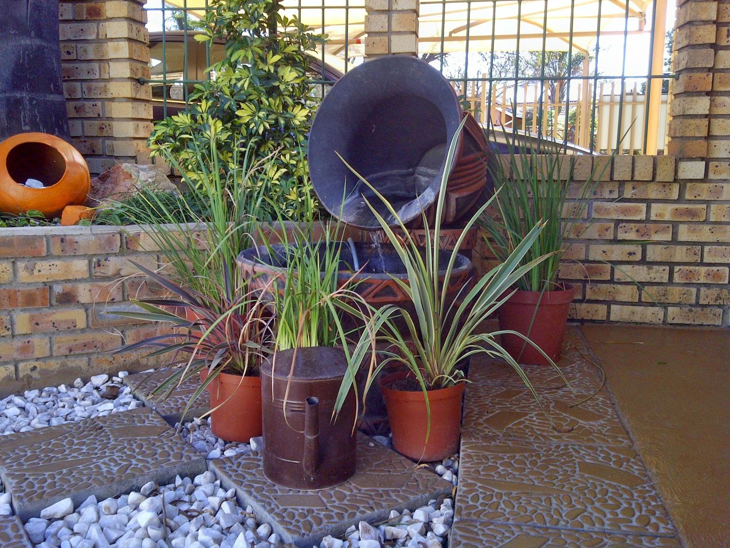 Ukarimu Guesthouse entrance garden with water feature